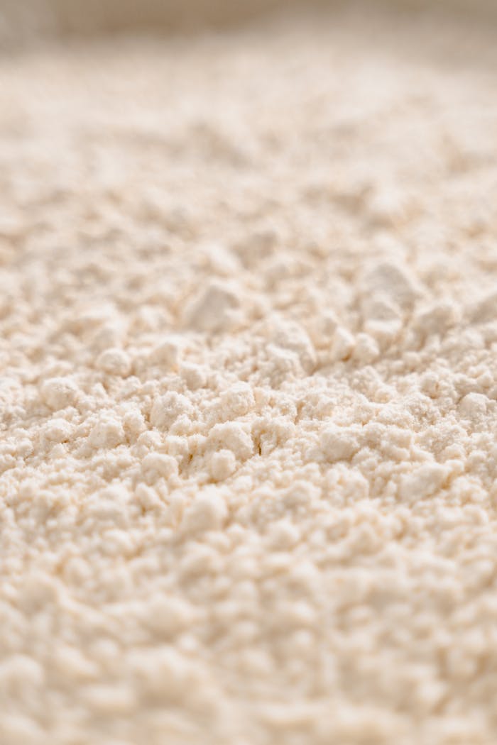 Close-up image of white flour texture, showcasing its fine, powdery consistency.